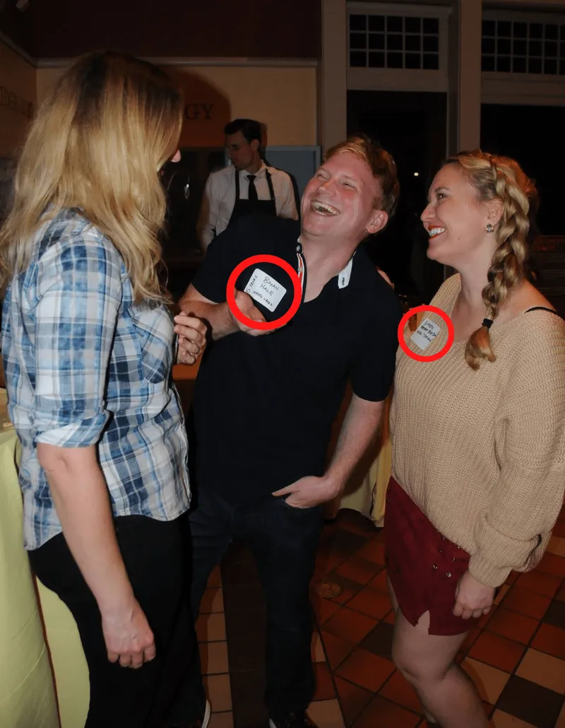three people laughing at a party