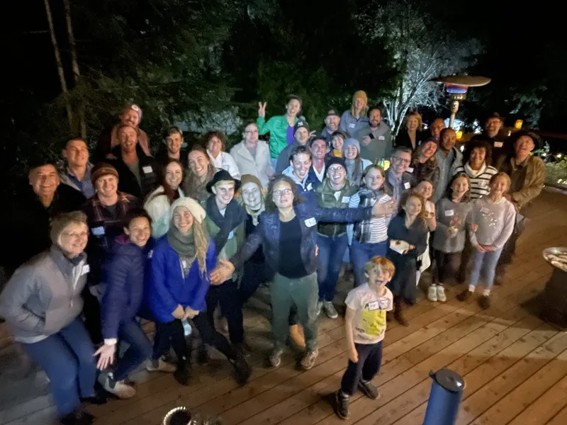 group of people with name tags smiling outdoors