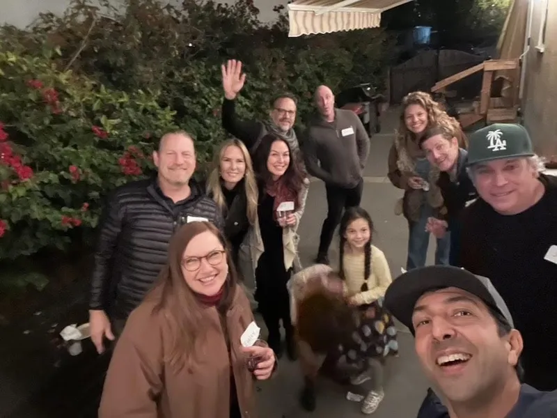 group of people with name tags smiling outdoors