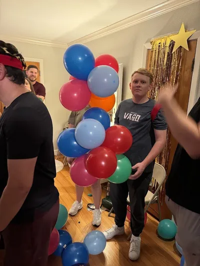 Guest holding balloons and celebrating at a 30th birthday party