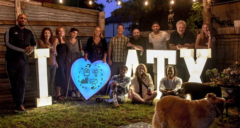 group of people smiling outdoors with text 'I heart ATX'
