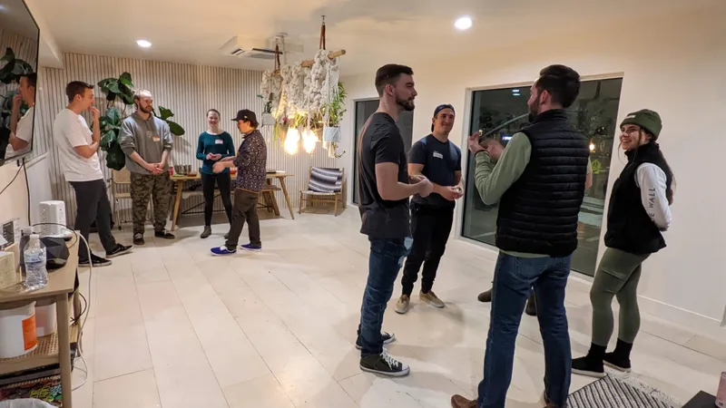 8 people grouped in 2 talking to each other
