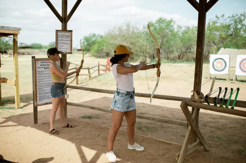 2 girls doing archery