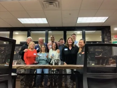 group of people smiling with nametags