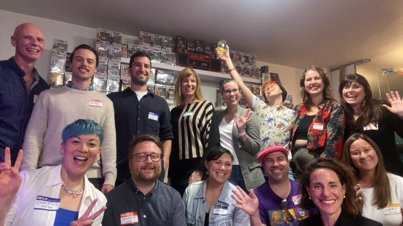 group of people smiling with nametags