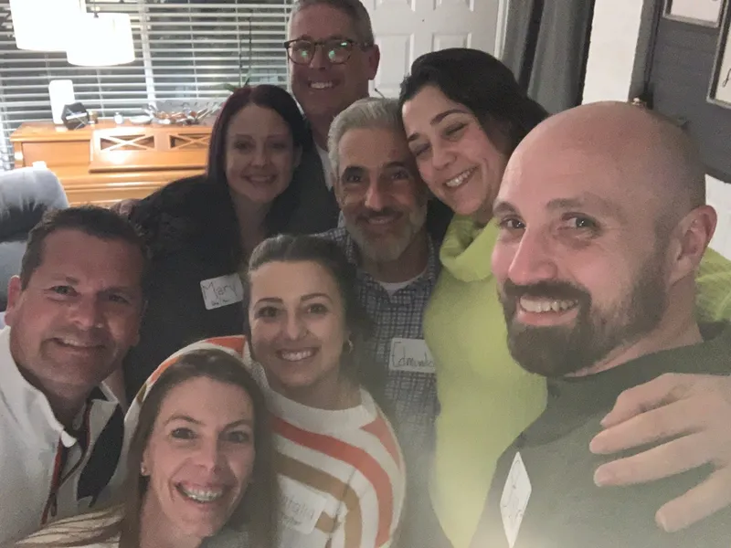 group of people with name tags smiling