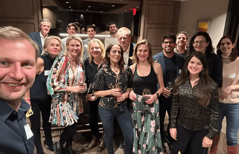 A group of people smiling and looking at the camera.