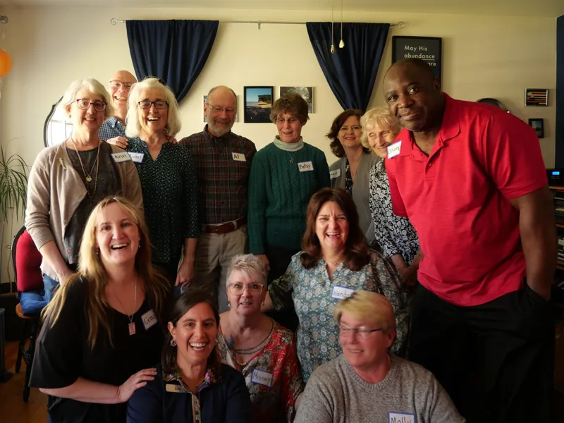 group of people smiling with nametags