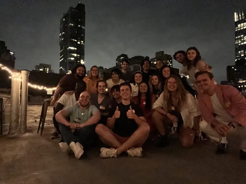 group photo of people on a roof top with name tags