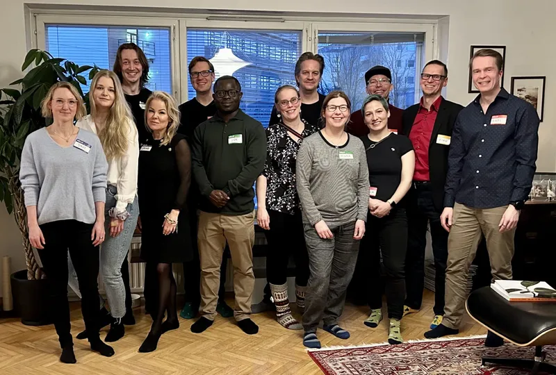group of people smiling with nametags