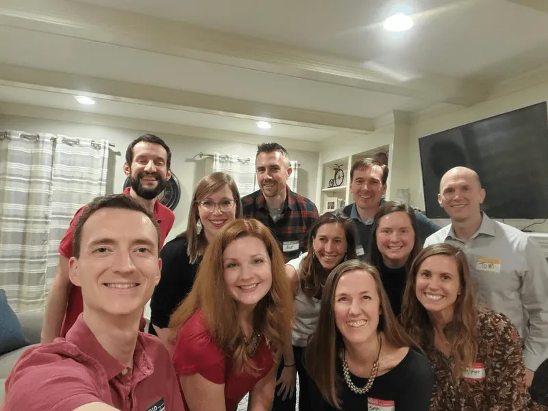 group of people smiling with nametags