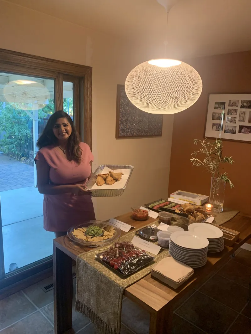 Jinal holding one of the food served at their party.