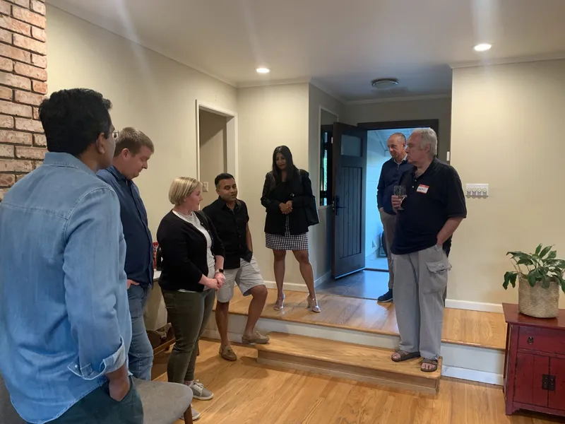 Kunal's guest standing and circling to talk with each other.