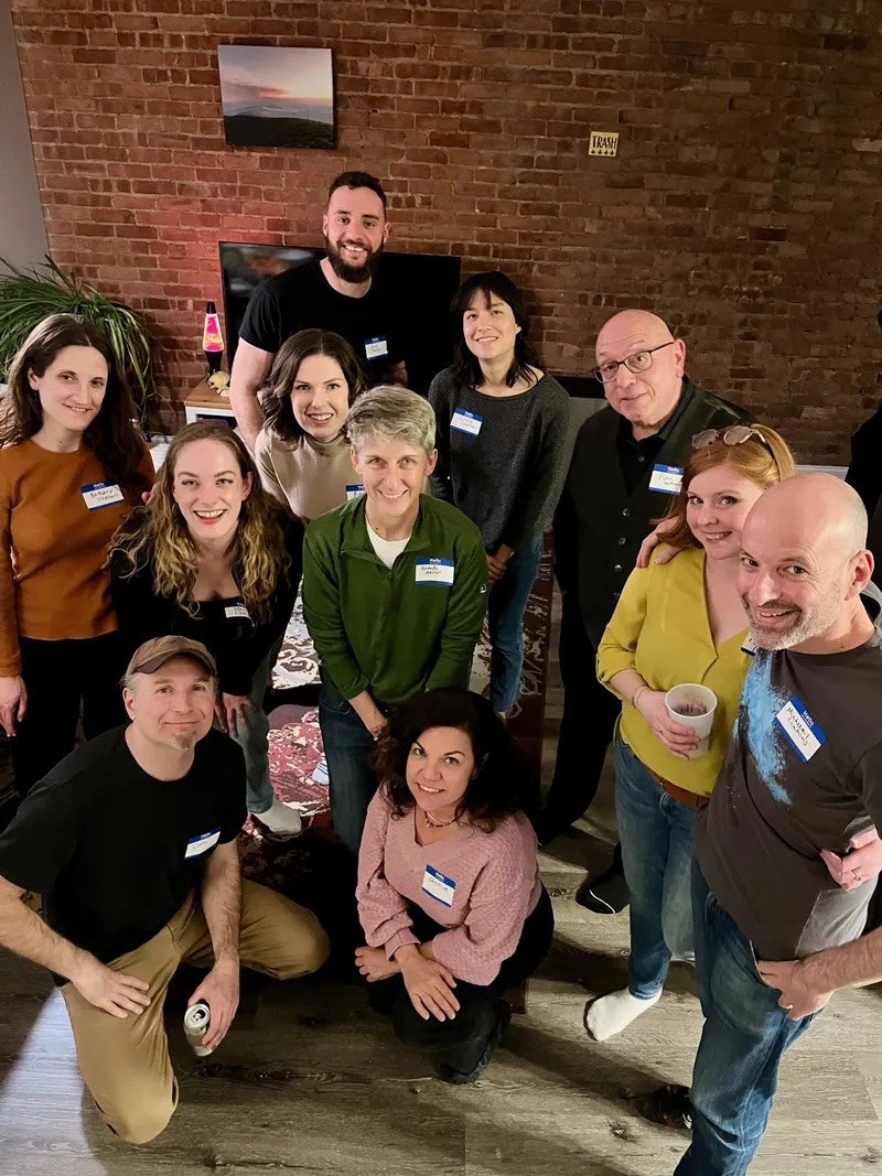 group of people smiling with nametags