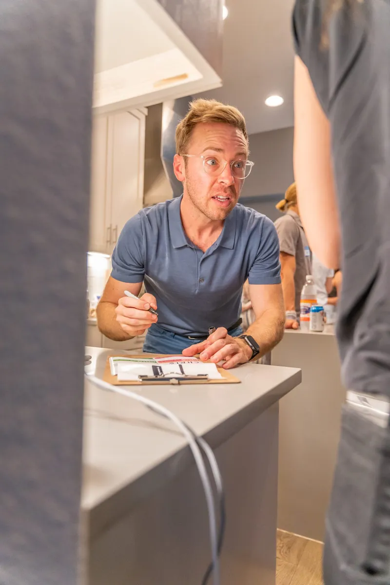 A man holding a pen and name tags