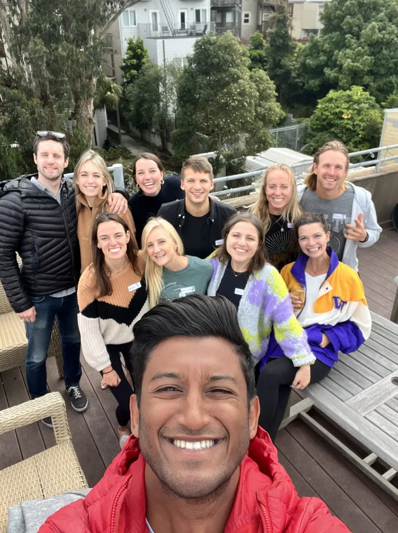 group of people with name tags smiling outdoors