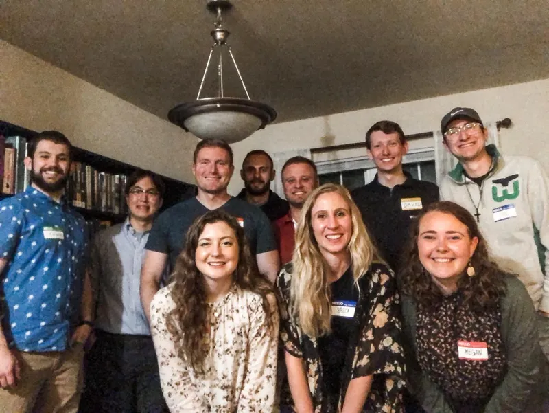 group of people smiling with nametags