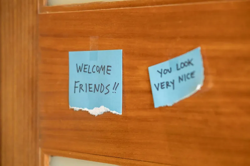 a photo of a door zoomed in with a note that says 'Welcome friends!!' and 'You look very nice' for your housewarming party