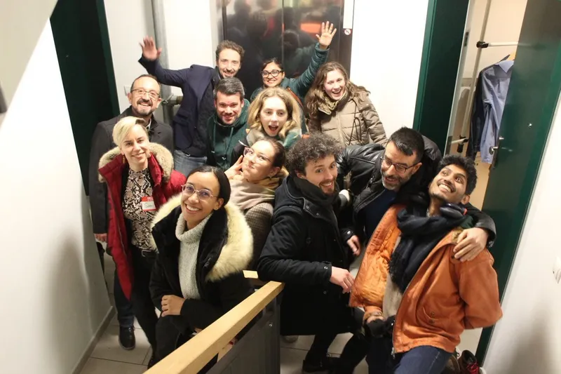 group of people posing at the foot of the stairs