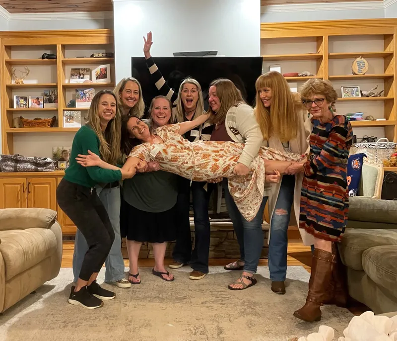 group of women holding a girl