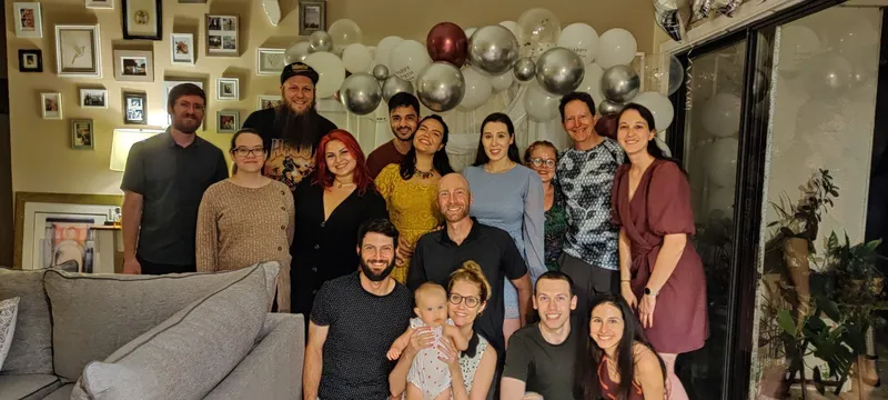 group of people smiling with balloons