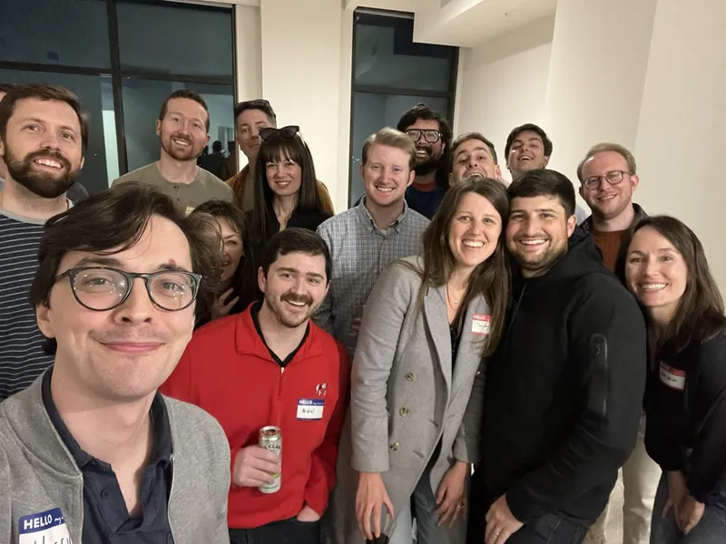group of people smiling with nametags