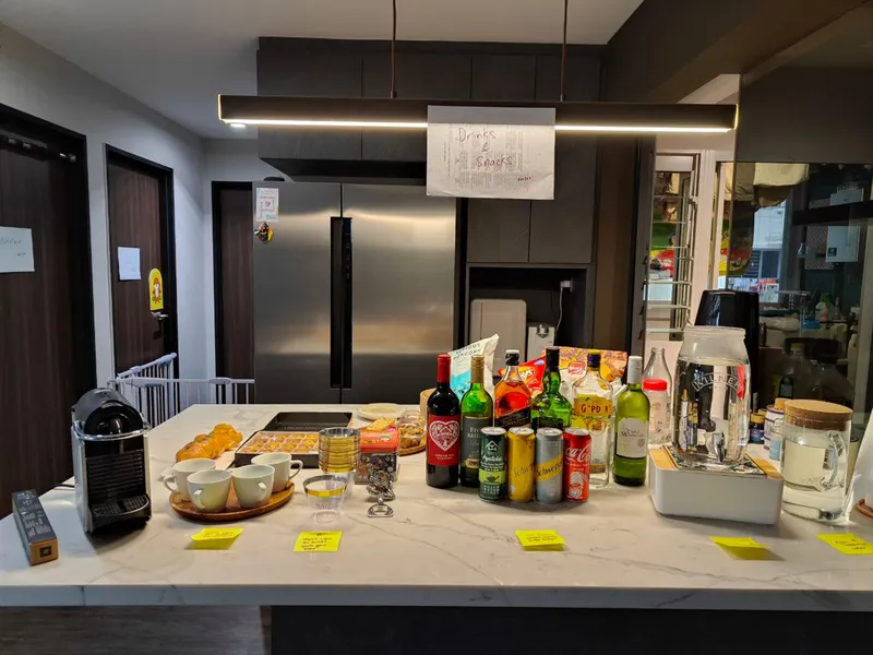 Island counter with snacks including breaks, cheese, grapes, potato chips, and drinks